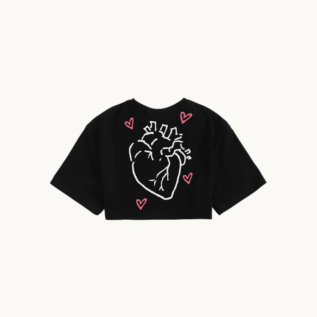 Black cropped t-shirt featuring a minimalist illustration of an anatomical heart surrounded by pink hearts.