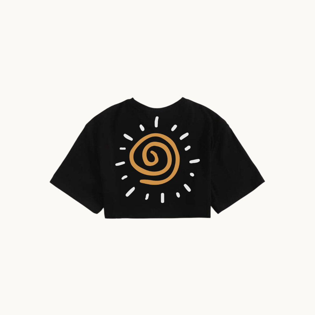 The back of the same black cropped T-shirt featuring a spiral sun design in yellow-orange, surrounded by white radiating lines symbolizing sunlight. -SKULLMASK
