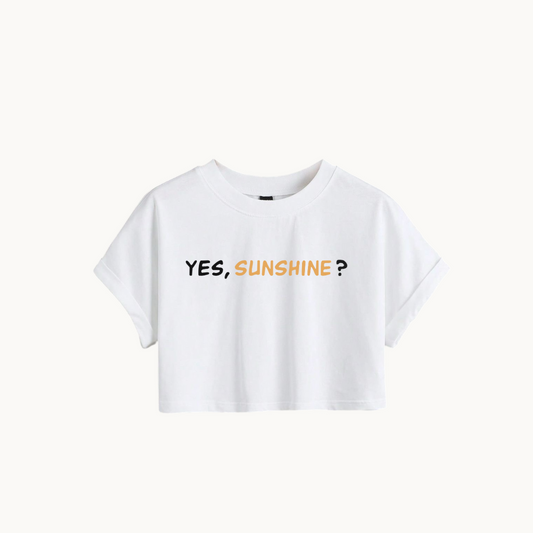  A WHITE cropped T-shirt with the phrase "YES, SUNSHINE?" printed in bold text on the front. The word "YES," is in white, and "SUNSHINE?" is in a warm yellow-orange color-SKULLMASK